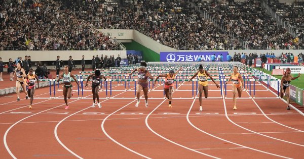 Women's 100m hurdles finish at the Shnaghai Diamond League with a big crowd.