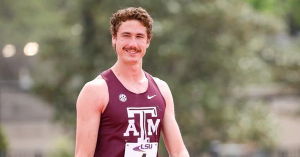 Sam Whitmarsh smiling before racing at a Track & Field meet.